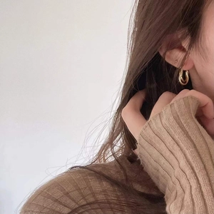Minimalist twisted gold hoop earrings in a sophisticated double loop knot design for women