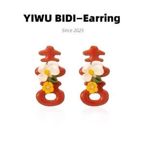 Detailed view of red double happiness stud earrings with floral pattern for weddings