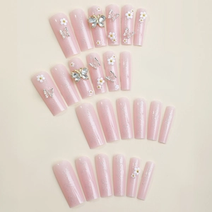 Silver butterfly and white flower charms on long coffin press-on nails in light pink