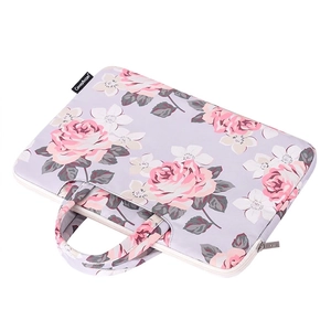 Floral laptop sleeve with pink roses on purple fabric and dual carrying handles