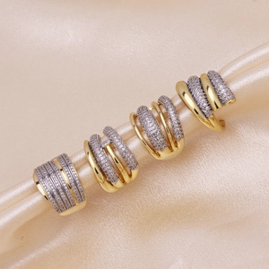 Luxury 18k gold plated striped ring with cubic zirconia on silk background