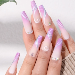 Detailed view of long coffin press-on nails with purple gradient, swirls, and rhinestones