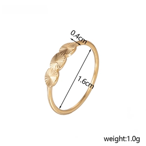 Detail view of golden band ring with sun patterns showing 1.6cm size and 1.0g weight