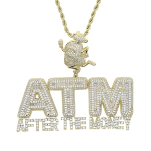 Close-up of gold ATM money bag pendant with shimmering cubic zirconia stones