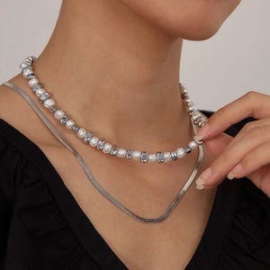 Double-layered necklace with white pearls, hematite beads, and a sleek silver snake chain