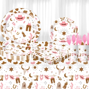 Pink cowgirl western party supplies set with cow print plates, cups and napkins