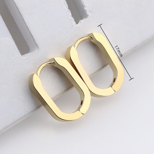 Detailed view of golden oval huggie earrings with a 17mm length measurement guide