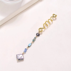 Exaggerated golden snake-shaped hair ring with blue crystal beads and purple stone pendant