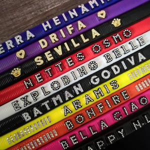 Detailed view of colorful DIY 8mm rhinestone letters on adjustable leather slide bands
