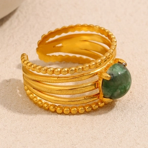 Detail of 18K gold-plated layered ring featuring a vibrant green gemstone inlay