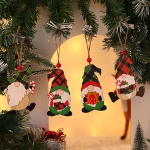 Set of four painted wooden Christmas gnome ornaments hanging on a festive tree branch
