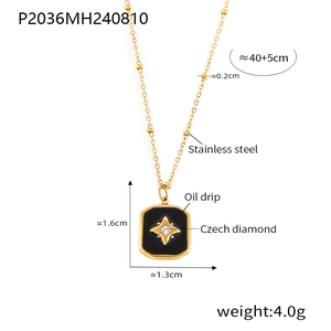 Detail view of gold-plated stainless steel star pendant necklace with black oil drip effect