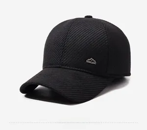 Close-up of winter baseball cap with mountain badge and twill texture in black