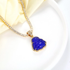 Close-up of a blue opal Buddha pendant with gold tennis chain and sparkling zircons