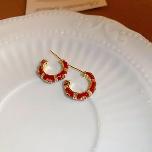 Geometric C-shaped gold plated earrings with red enamel and red zircon accents