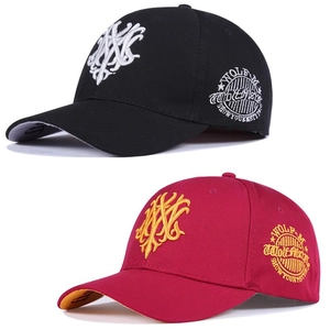 Close-up of Gothic embroidery details and stitching on black and red baseball caps