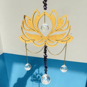 Close-up of golden lotus suncatcher with purple amethyst beads and faceted crystal ball