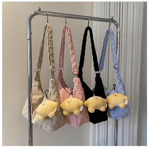 Detailed view of checkered crossbody bags in four colors with star plush pendants