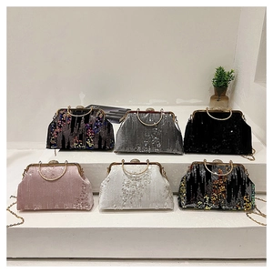 Close-up of sequined evening bags in six colors with gold metal handles and chain straps