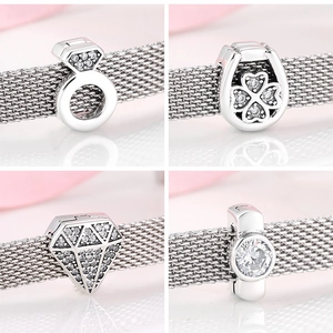 Detailed views of S925 sterling silver charms with horseshoe, diamond and clover motifs