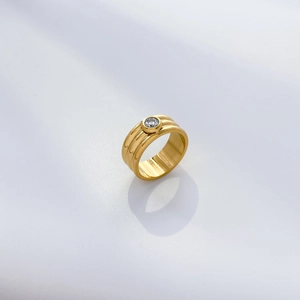 Detail of 18K gold-plated wide-band ring with spiral texture and white zircon stone