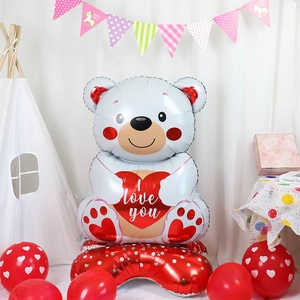 Macro view of teddy bear foil balloon holding a red heart with I Love You text