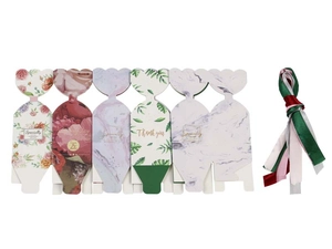 Detail of assorted paper candy boxes with floral patterns and colorful ribbon ties