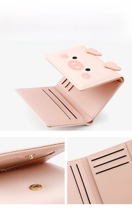 Close-up of the metal snap fastener and internal card slots on this pink trifold wallet