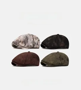 Close-up of four vintage flat caps in grey, black, brown, and olive green textures
