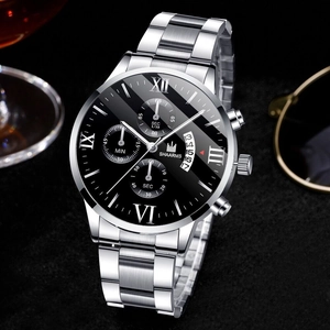 Detail of silver stainless steel watch with black dial and Roman numerals on dark surface