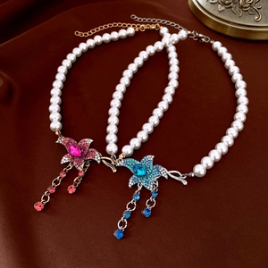Detail of French vintage pearl necklaces with rhinestone flower pendants and tassels