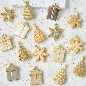 Golden Christmas tree snowflake and gift box ornaments on white glitter background
