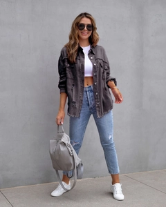 Detailansicht der ausgefransten Kanten und der Denim-Struktur der Jeansjacke am Model