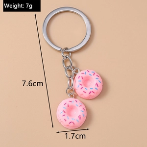 Detail view of pink donut keychain with size specs 7.6cm length and 7g weight