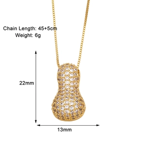 Detail view of gold peanut pendant with zircon stones showing size 22mm by 13mm and chain