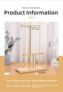 Detail of the multi-tier jewelry display stand with golden metal rods and wood base