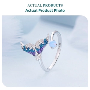 Detail of S925 silver mermaid tail ring with blue enamel and opal stone inlay