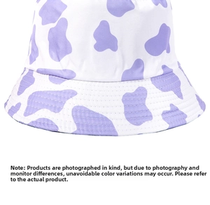 Detail of a purple and white cow print bucket hat featuring high-quality twill cotton fabric