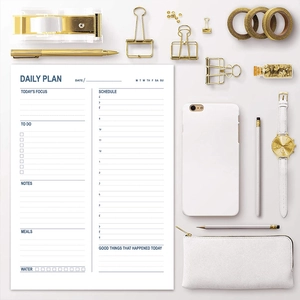 Flat lay of daily planner notepad with hourly schedule and task list on grey background