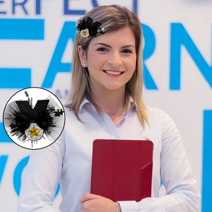 Detail of black bow hair clip with silver sequin stars and mesh fringe for graduation
