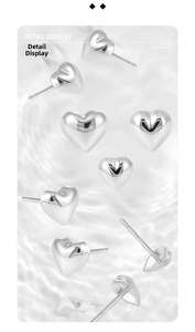 Detailed macro view of S925 sterling silver heart earrings with polished finish