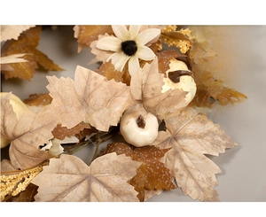 Detail of autumn wreath with maple leaves, white pumpkins and daisies for fall decor