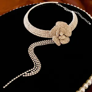 Silver flower tassel choker necklace with sparkling rhinestones on black velvet display