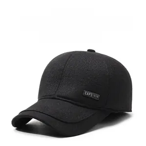 Detail of winter baseball cap with ear flaps featuring black herringbone wool texture