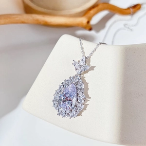 Macro detail of pear-shaped zircon pendant with exquisite micro-paved setting on silver chain