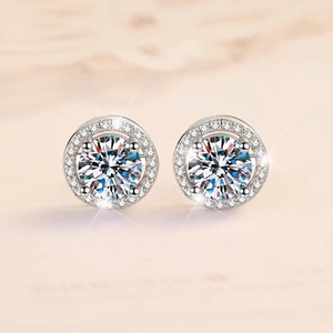 Detailed macro view of silver halo stud earrings with a round center stone and micro-pave