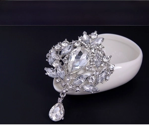 Macro detail of luxury silver brooch with teardrop crystals and vintage pave rhinestones