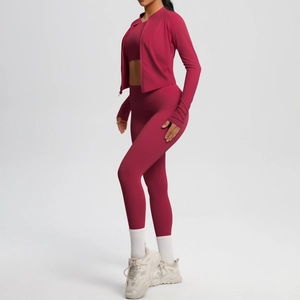 Detail view of burgundy 3-piece yoga set featuring a slim-fit jacket and high-waist leggings