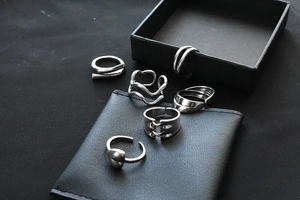 Detailed view of a six-piece silver minimalist open ring set with vintage heart and wavy designs