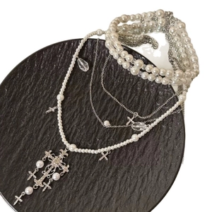 Elegant multi-layer pearl necklace with silver crystal cross pendants for a vintage look